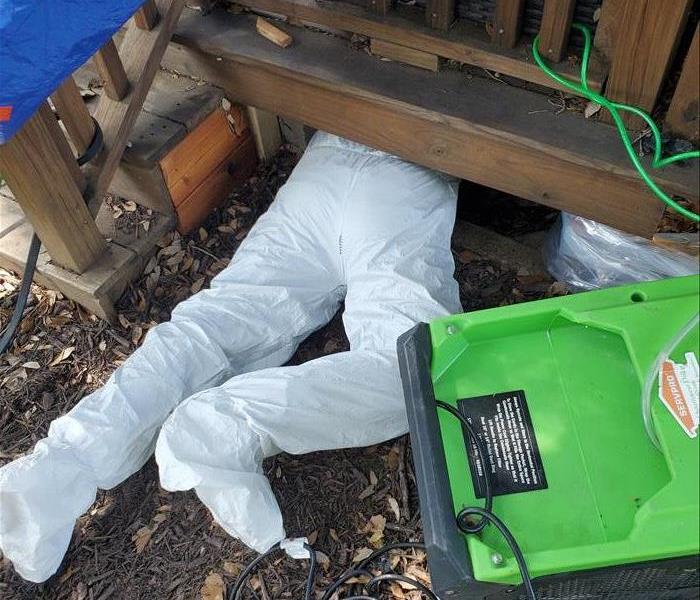 Man in Tyvek Suit Crawling into a Crawlspace
