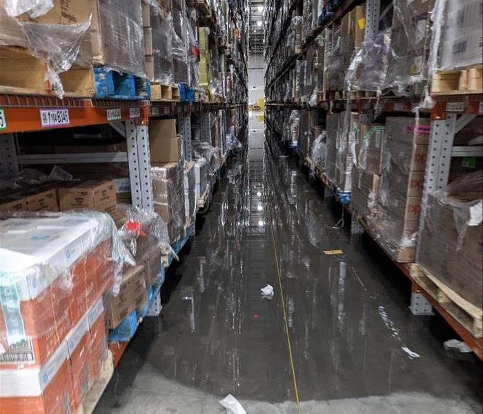 Tall, warehouse racking with water everywhere on the floor